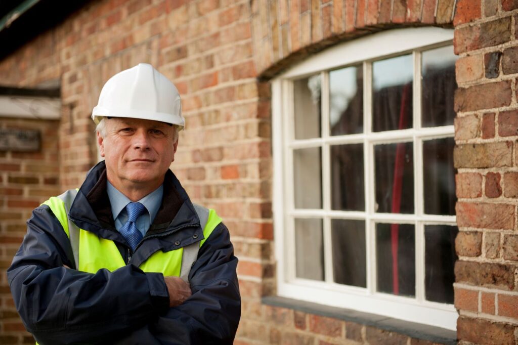 Surveyor in a hard hat ready to survey a buy to let property